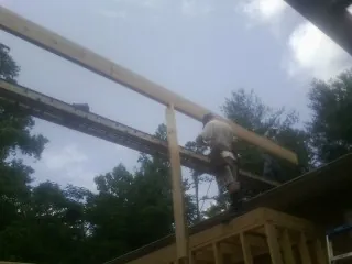 Carpenter setting a ridge beam over a new addition frame — Ice Dam Removal by Roofing Brothers in Van Wert